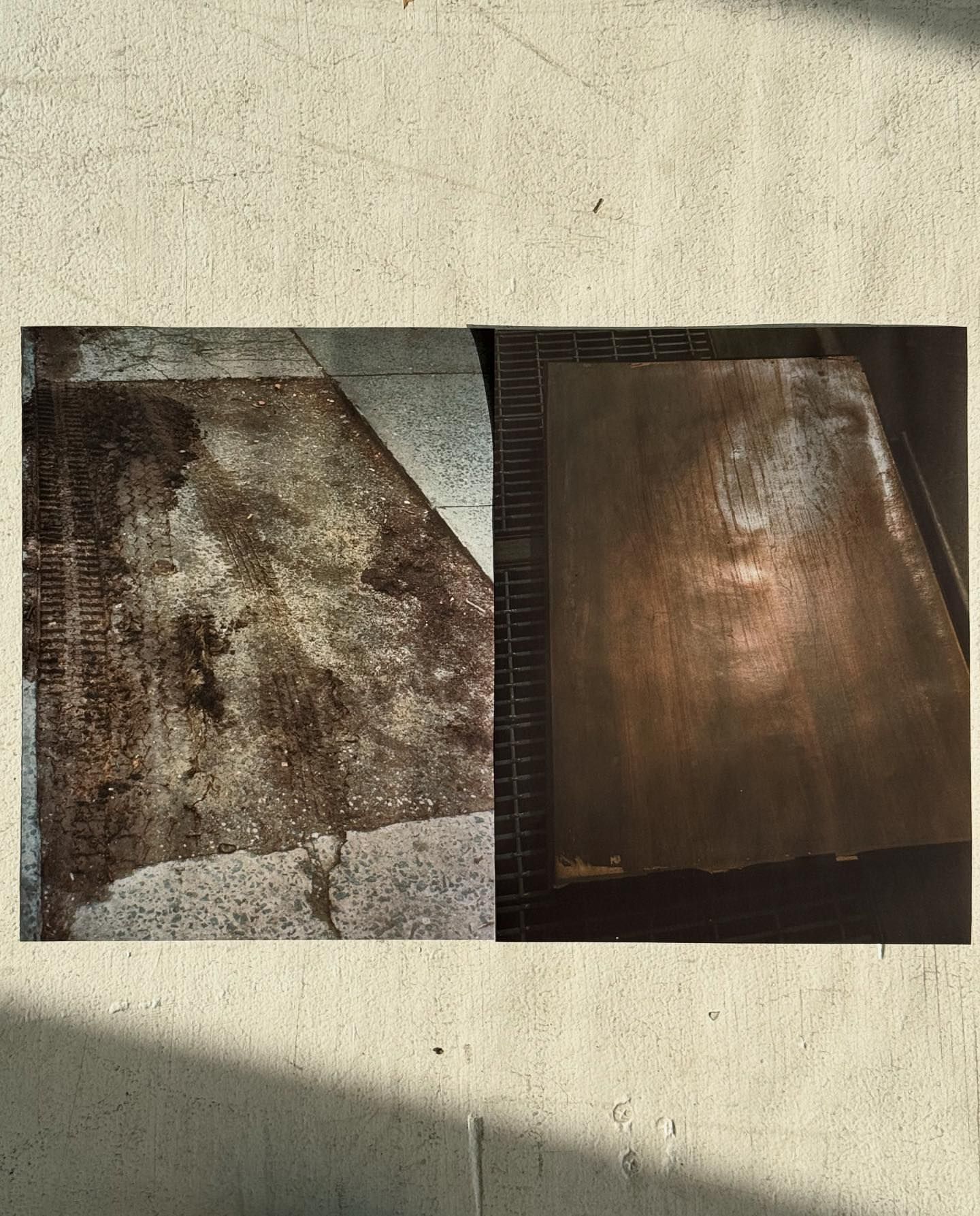 Concrete surface featuring dirt and tire tracks, with a contrasting rusted metal sheet, conveying texture and industrial tones.