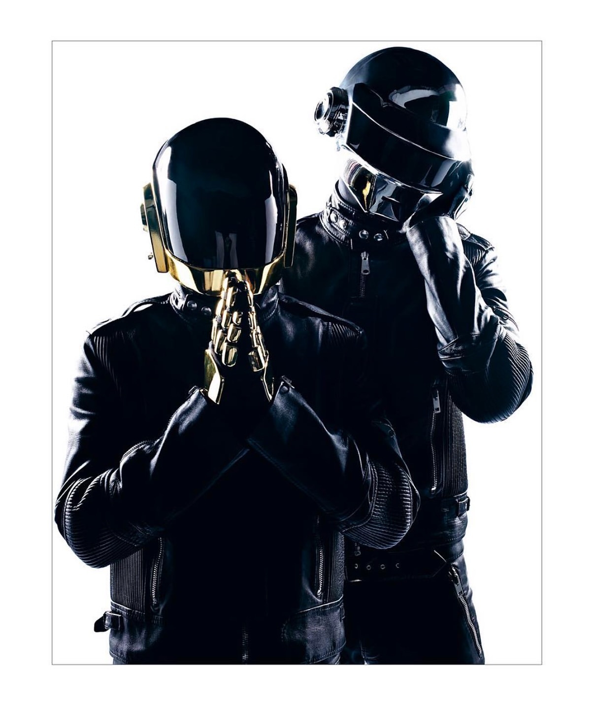 Two musicians wearing dark leather jackets and metallic helmets against a stark white backdrop for a Daft Punk-esque artistic photograph.