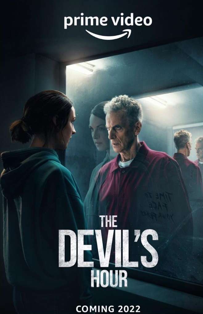 Movie poster for The Devil's Hour. A woman, a man and other people in the background. The poster has dark, muted tones.