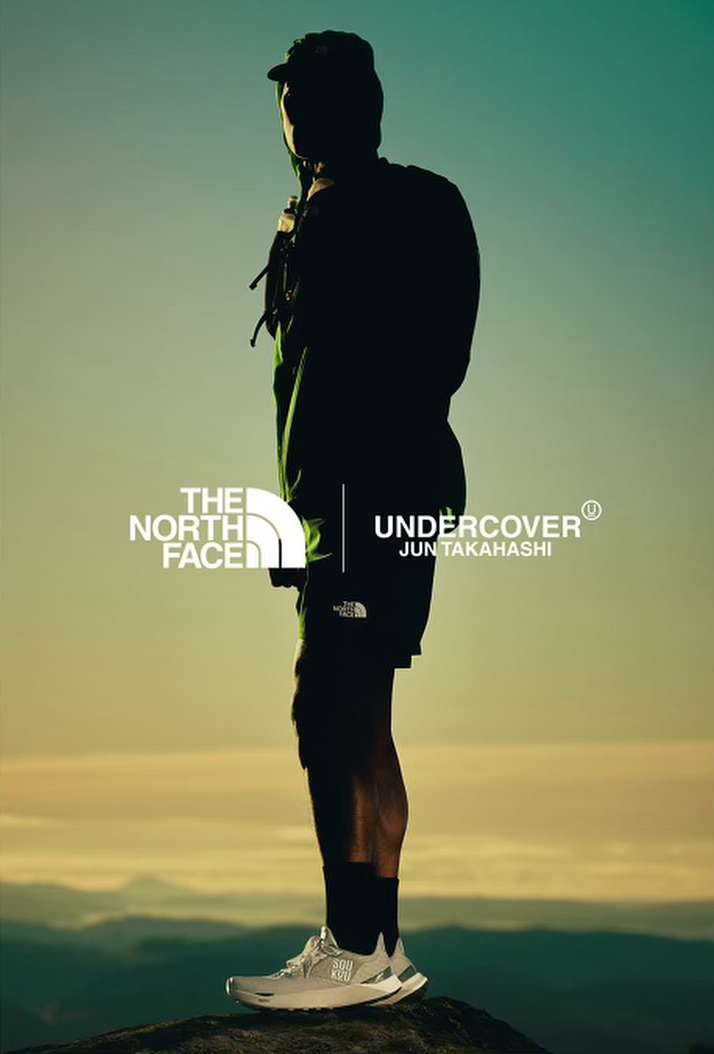 A person silhouetted against the sky wears athleisure apparel and running shoes, with The North Face Undercover Jun Takahashi logos.