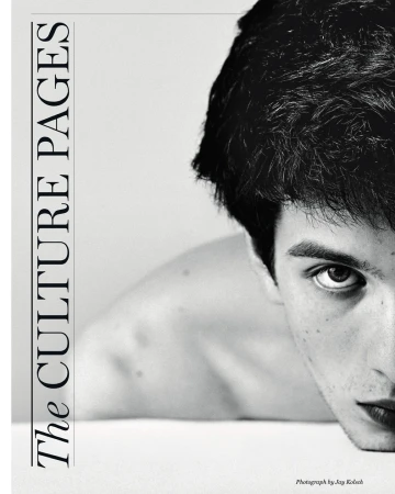 Monochromatic portrait of a young adult male looking intently at the camera, with a magazine cover design on the left side of the frame.