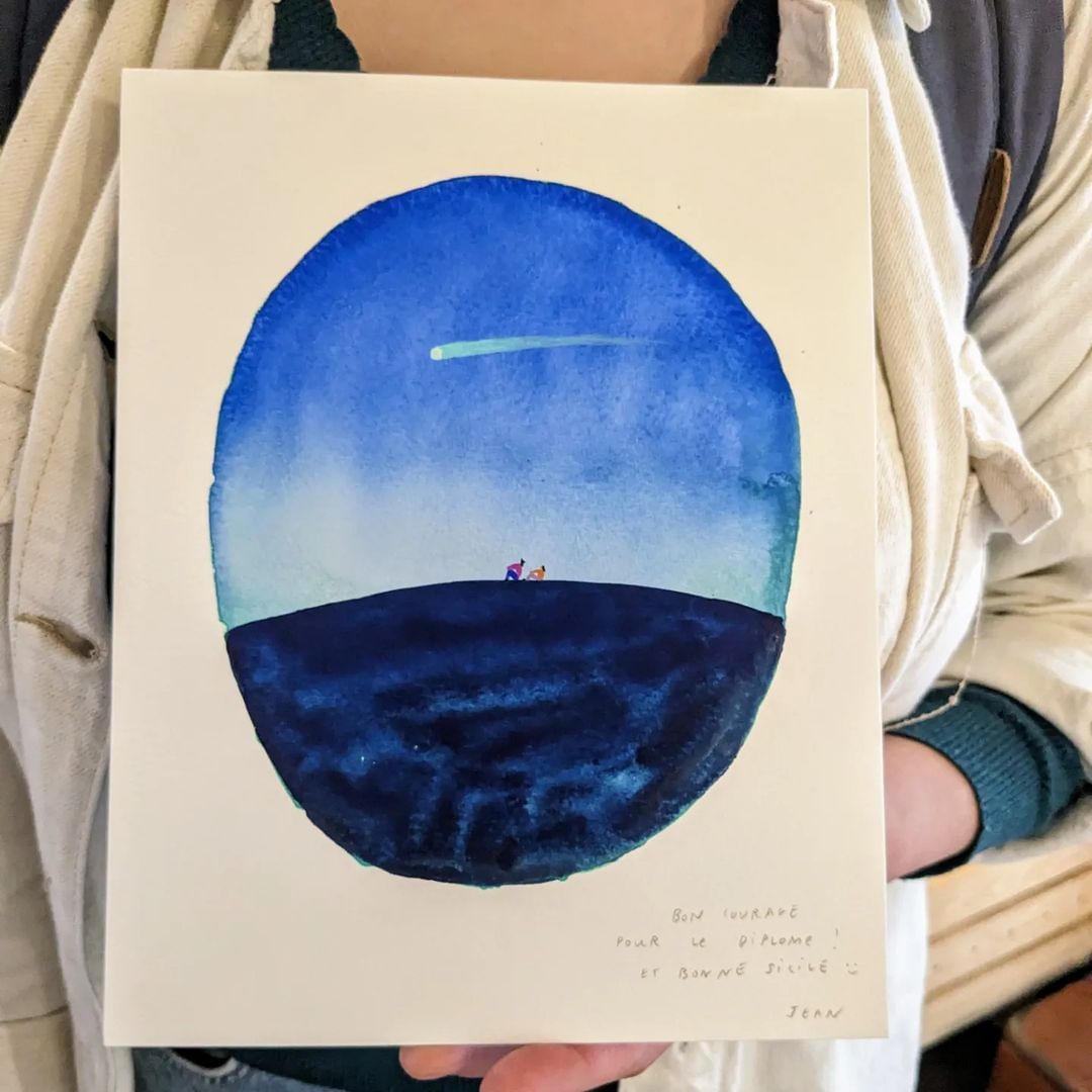 Watercolor art shows two figures on a dark blue hill watching a shooting star in a circle against a white background. 