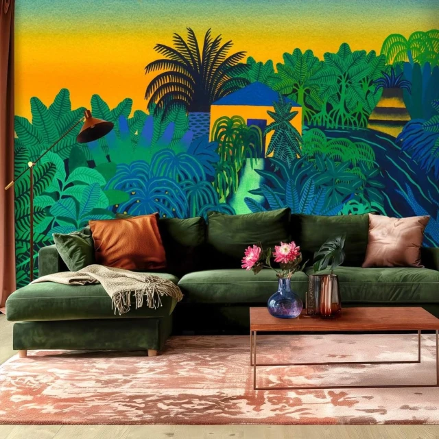 Green sectional sofa in a living room with a vibrant jungle wallpaper backdrop and warm-toned area rug.