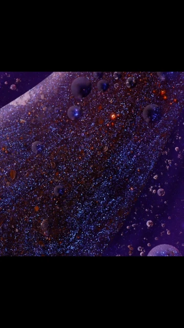 Abstract close-up shot of small liquid drops in varied sizes and hues of purple, blue, brown, and orange.
