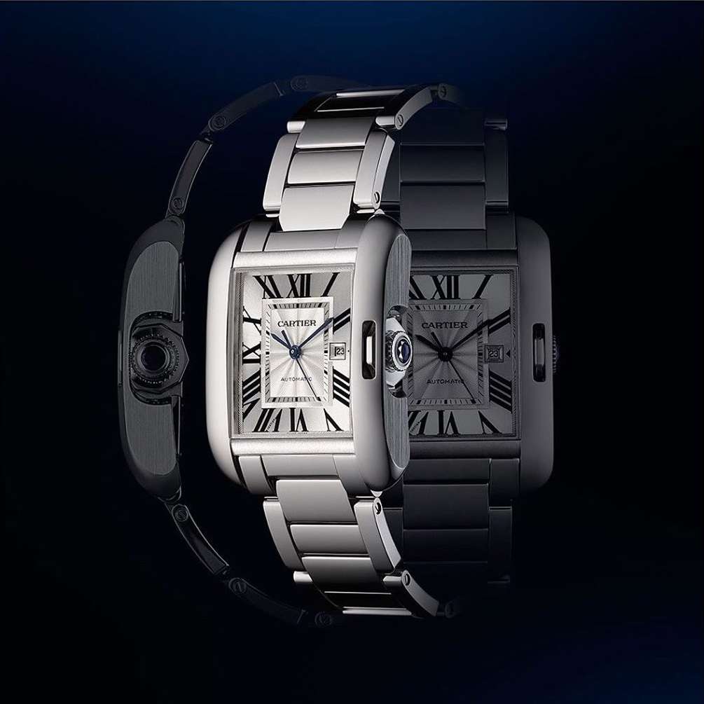 Elegant stainless steel Cartier Tank watch with a rectangular face, silver dial, and Roman numeral hour markers displayed in a studio setting.