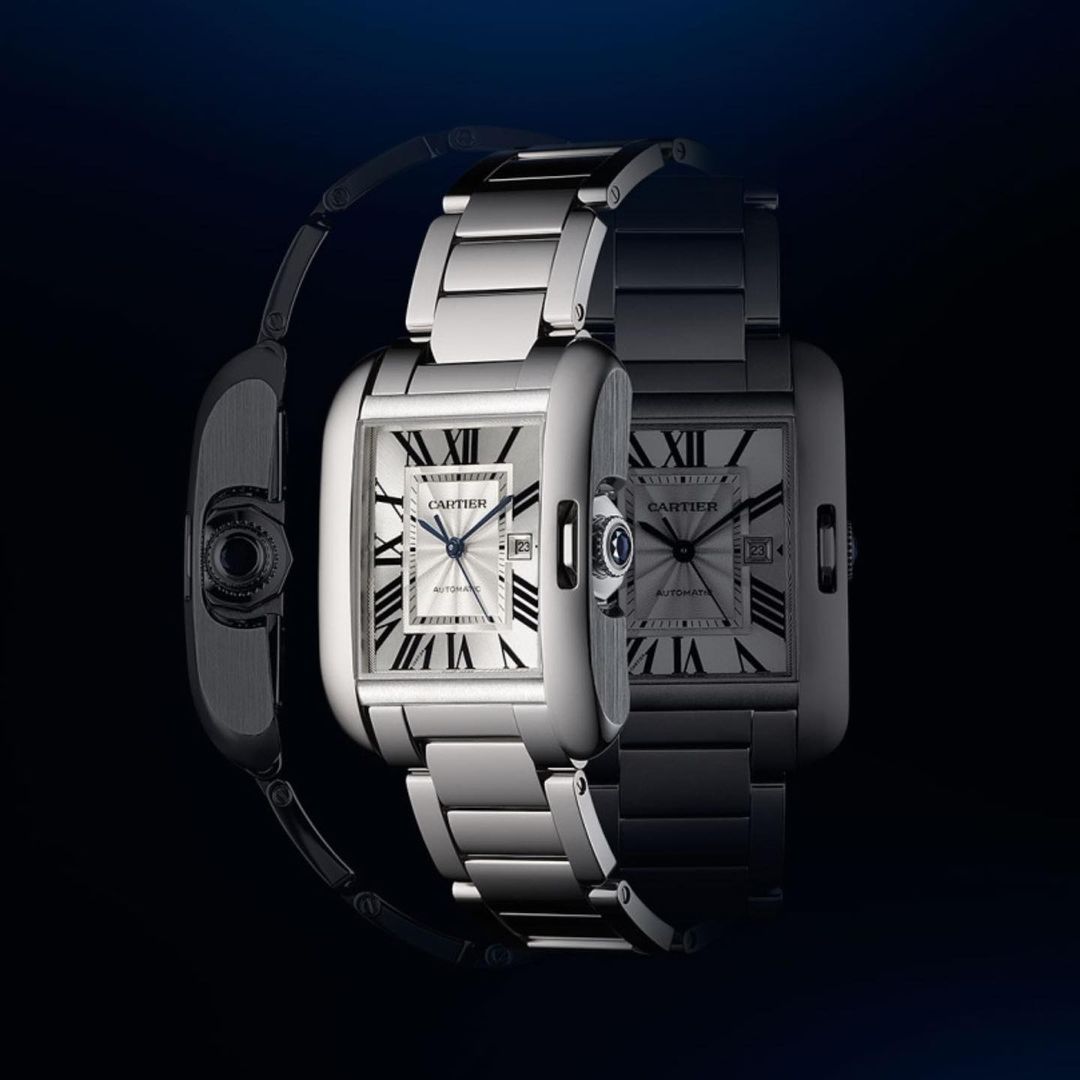 Three luxury Cartier Tank watches are showcased in a studio setting, highlighting their stainless steel construction and elegant design.