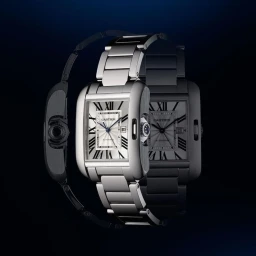 Close-up product photograph of a luxury silver wristwatch with Roman numerals against a dark blue background.