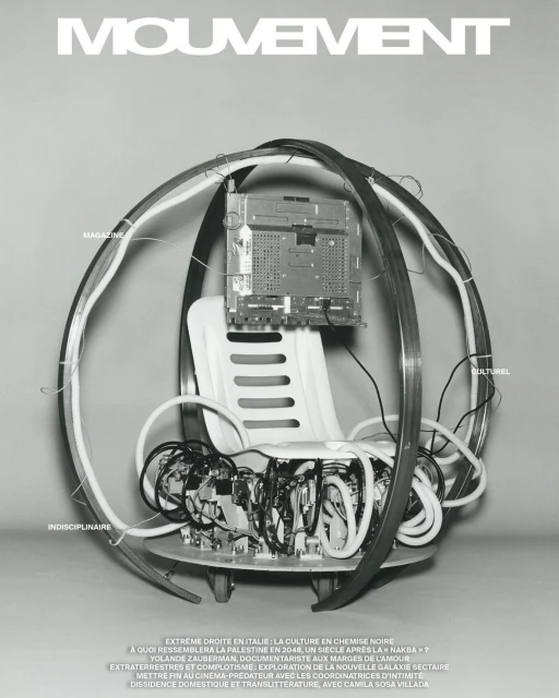 Monochrome image features a wired seat with what appears to be a magazine cover in the background and visible text throughout.