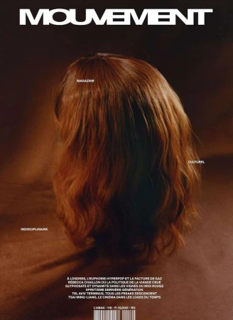 Magazine cover featuring a head with auburn hair, viewed from the back. The cover is cream and brown with magazine text and details.