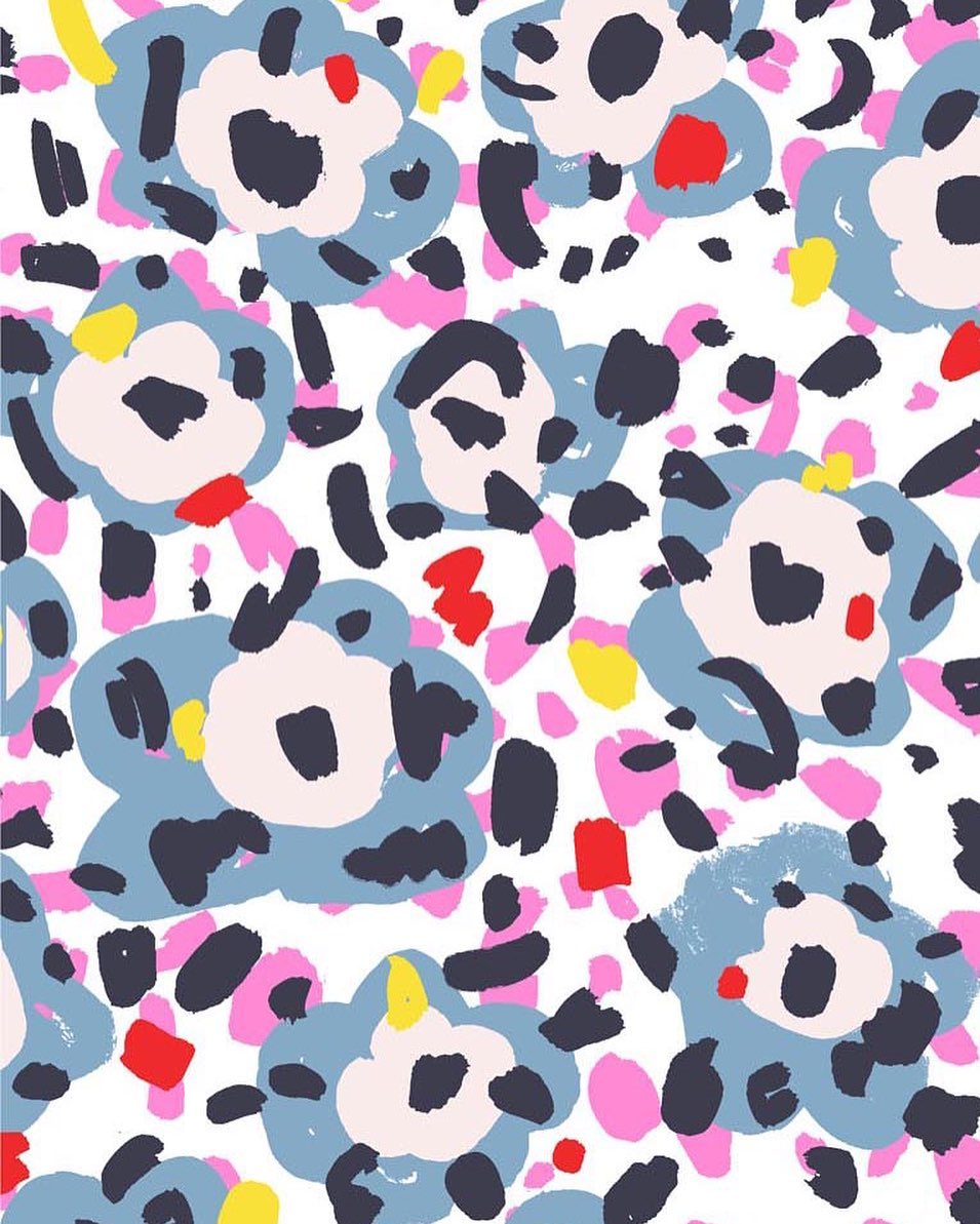Abstract floral pattern with blue flowers, navy dashes, pink circles, and yellow dots on a white background in a seamless design.