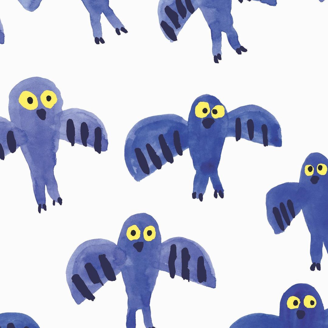 Seamless pattern featuring repeating watercolor illustration of blue birds with yellow eyes on a white background.