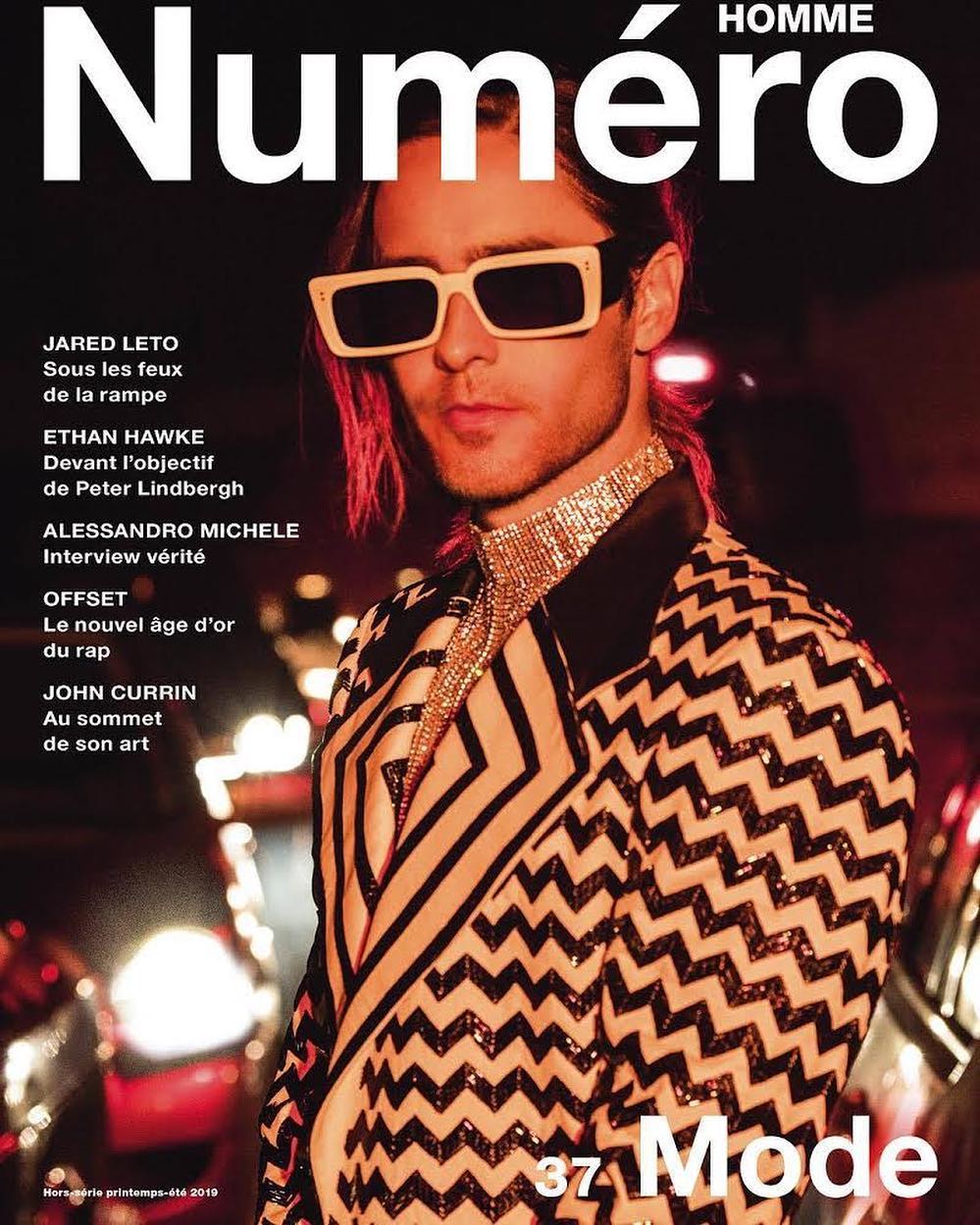 Jared Leto on a Numéro Homme magazine cover wearing a patterned blazer and sunglasses, featuring text about fashion and interviews.