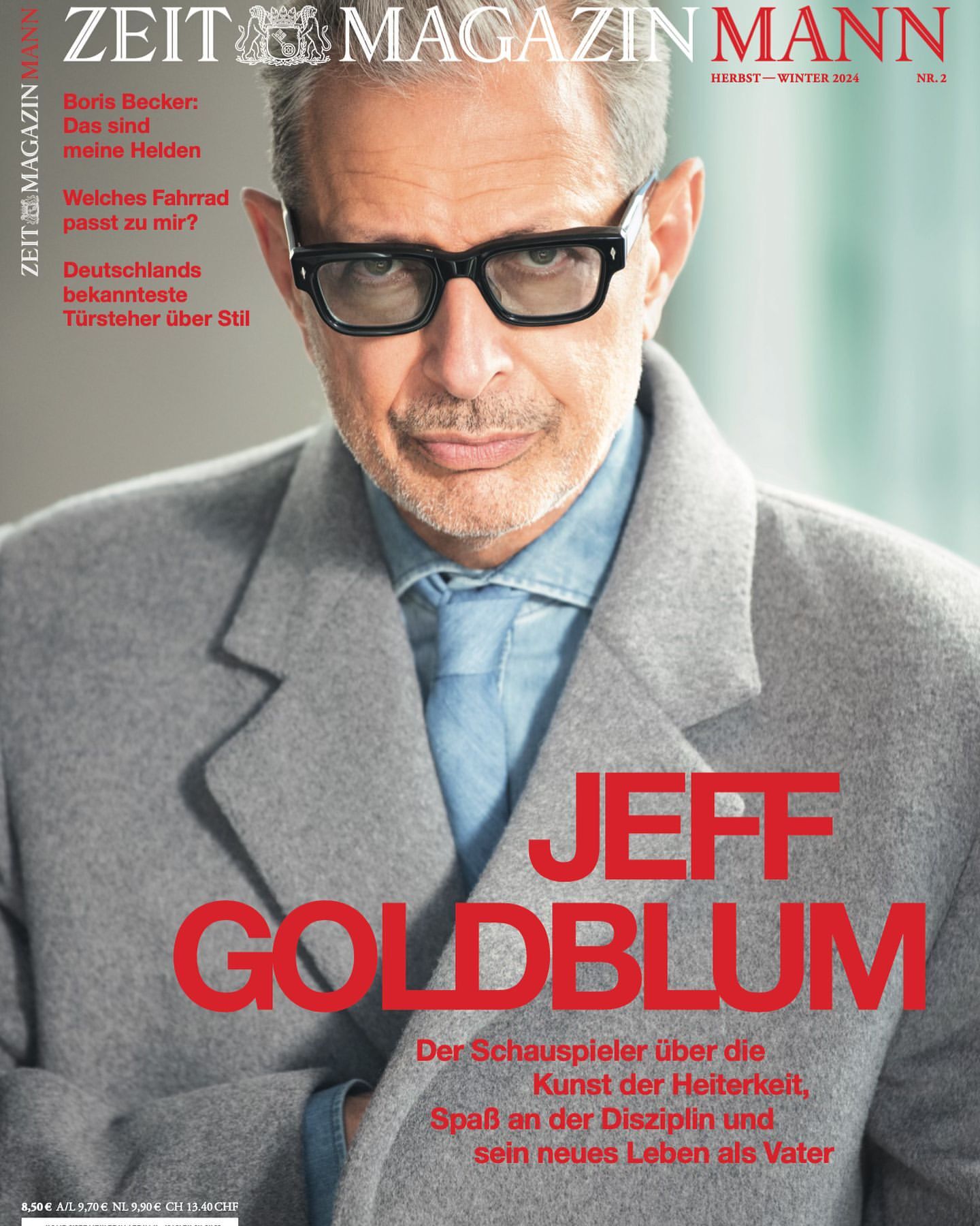 Magazine cover featuring Jeff Goldblum in a grey coat and black glasses, promoting an article on acting and life as a father.
