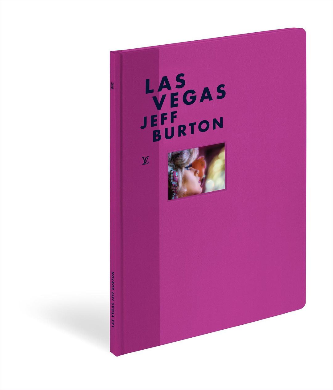 The book 'Las Vegas' by Jeff Burton with a cut-out showing two people kissing. The book is bright pink, in portrait format and isolated.