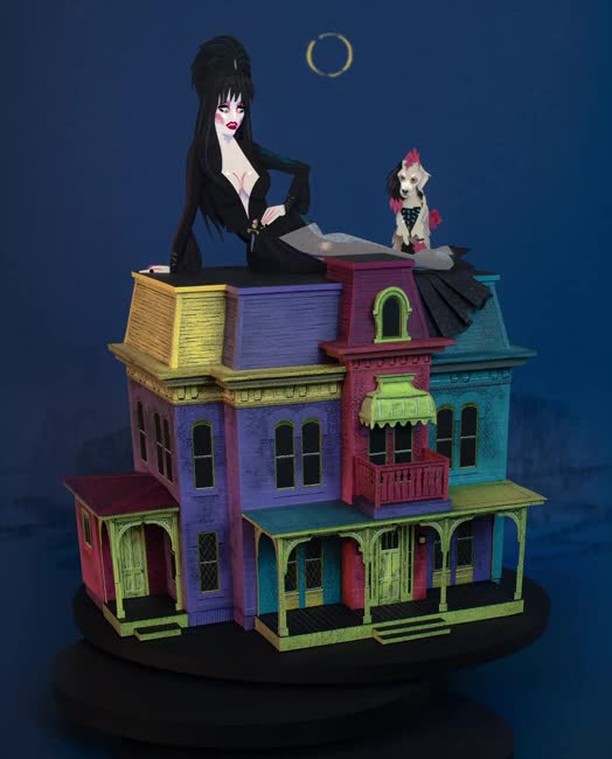 Illustration of a cartoon Elvira character sitting atop a brightly coloured haunted house with a poodle on the roof.