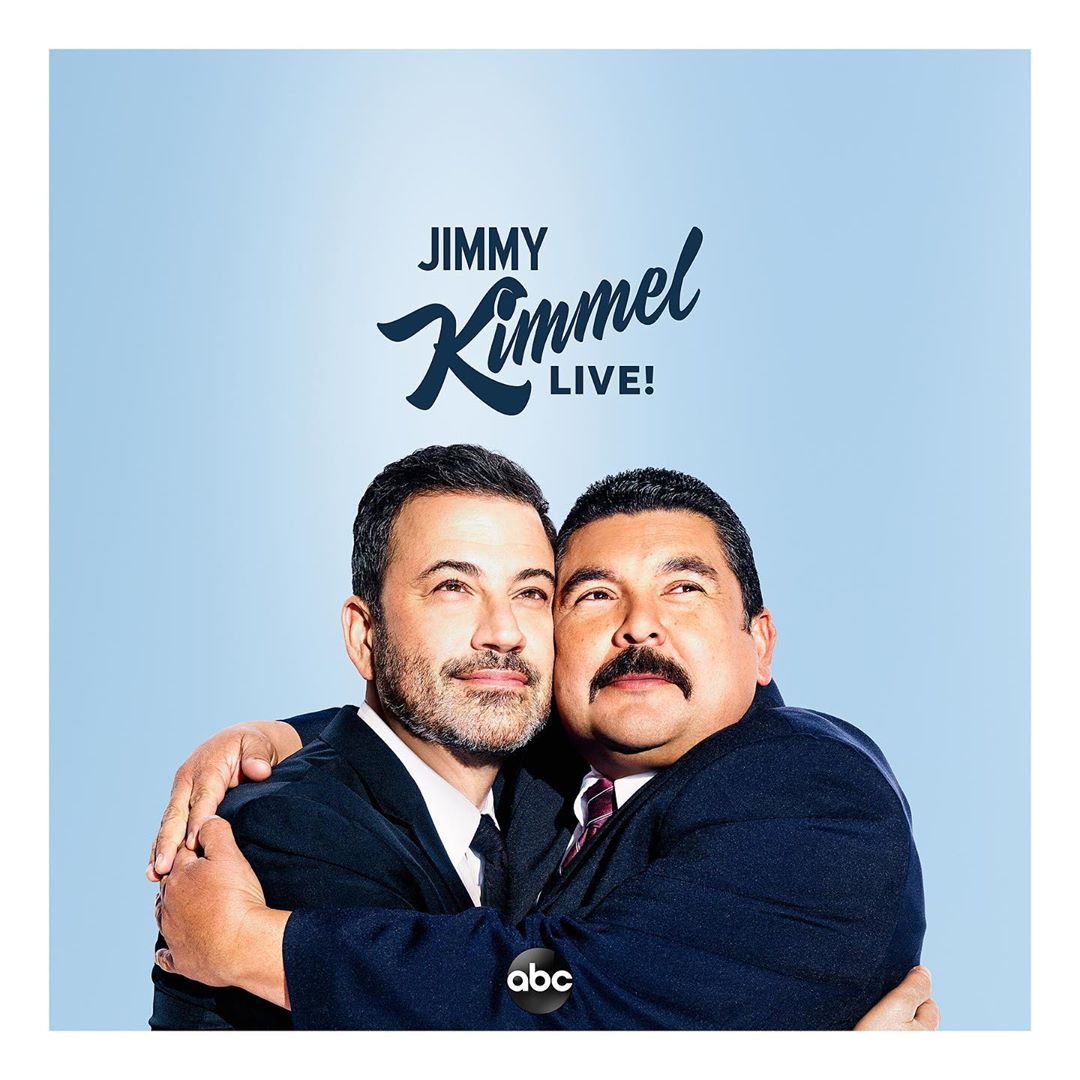 Promotional image for Jimmy Kimmel Live! features Jimmy Kimmel and George Lopez embracing against a gradient blue background.