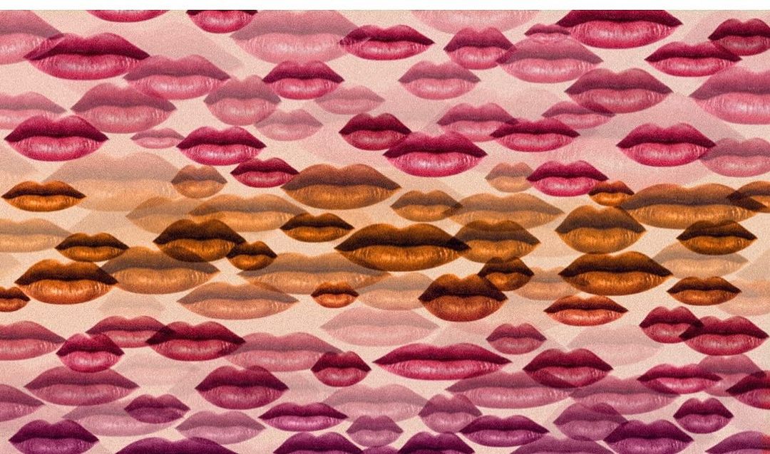 Abstract background featuring a pattern of floating lips in shades of pink, peach, and brown, creating a unique visual texture.