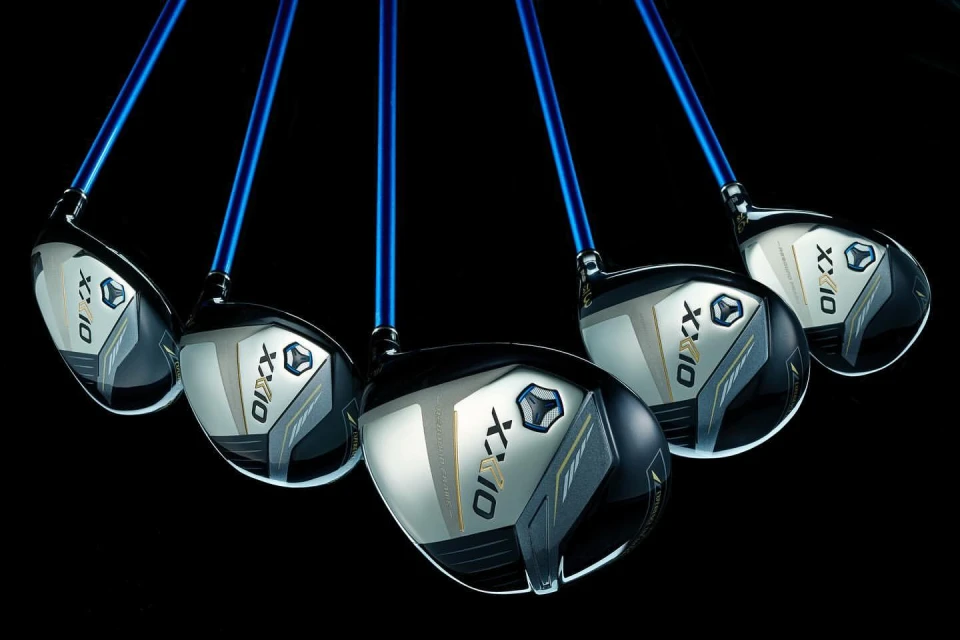 A set of five golf drivers is displayed against a black background, with blue shafts and silver and black club heads.