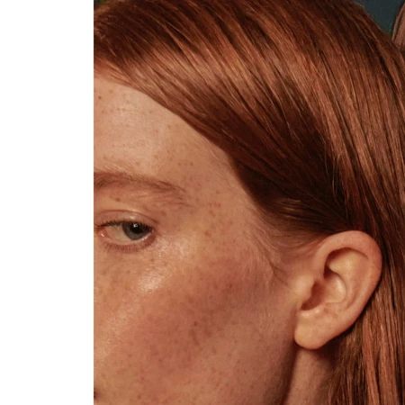 Close-up portrait of a woman with red hair and freckles looking sideways by photographer Jem Mitchell.