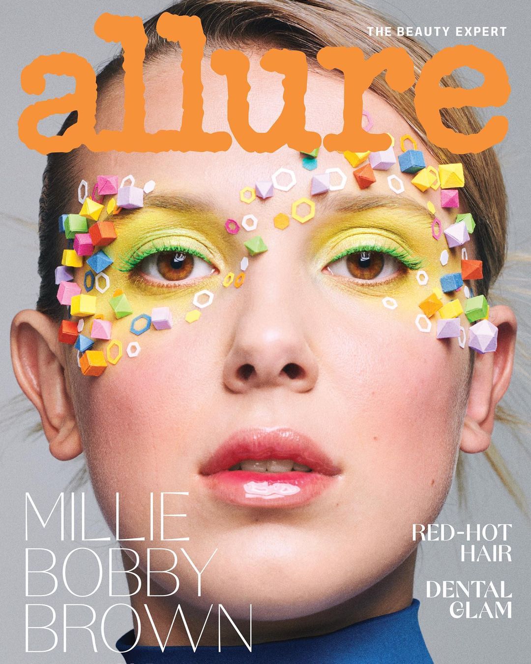 Close-up beauty shot of Millie Bobby Brown on the cover of Allure, featuring bright yellow eye makeup and colorful geometric embellishments.
