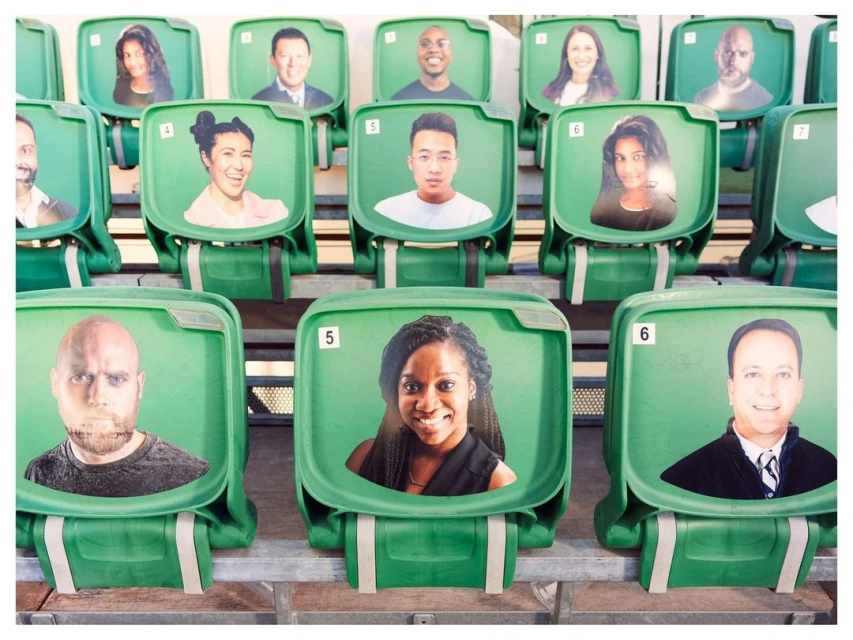 Audience substitute using headshot photos in a stadium seating arrangement, showcasing fan representation and event attendance alternatives.