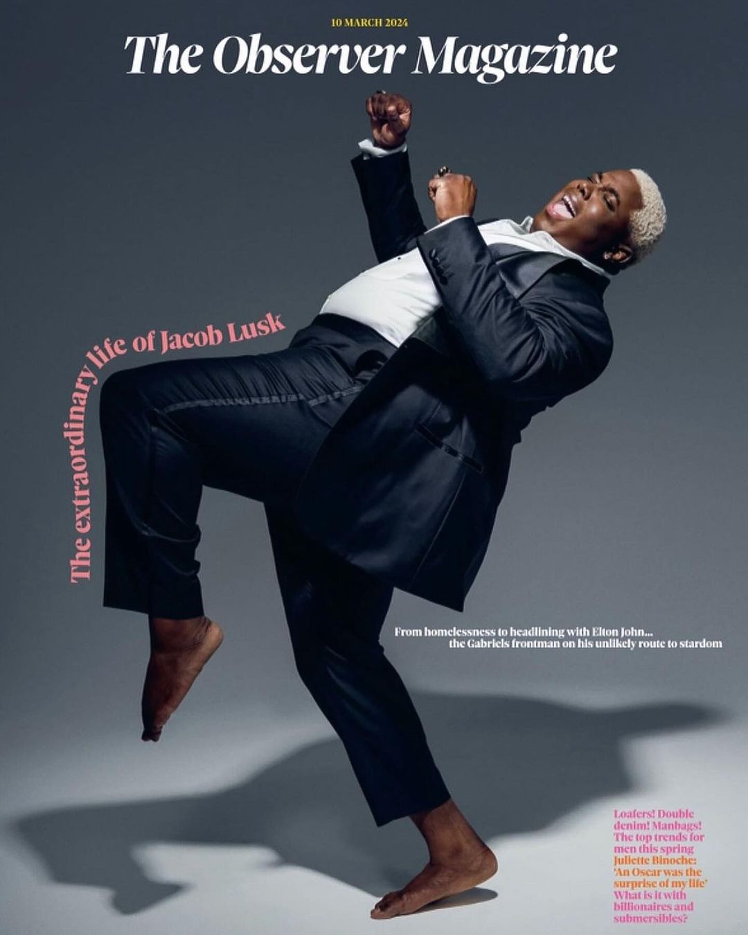 Magazine cover featuring Jacob Lusk in a suit, dancing barefoot against a grey backdrop. Text overlay includes the magazine's name.