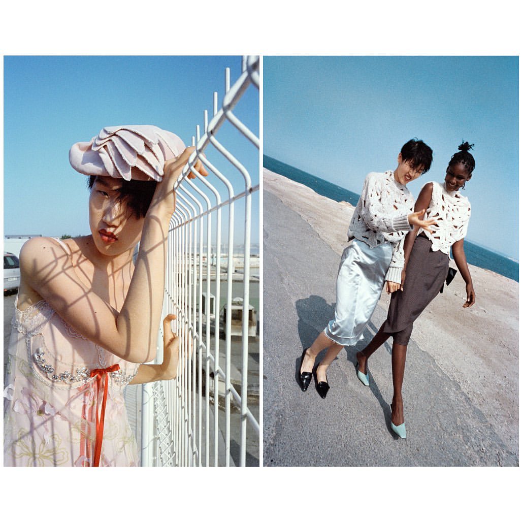 Two images show diverse models wearing patterned tops, skirts, and heels on a concrete path with a fence and blue sky backdrop.
