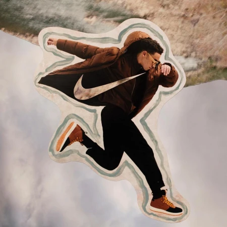 Collage of a man in a brown puffer jacket leaping against a sky background, featuring a prominent Nike swoosh logo on the jacket.
