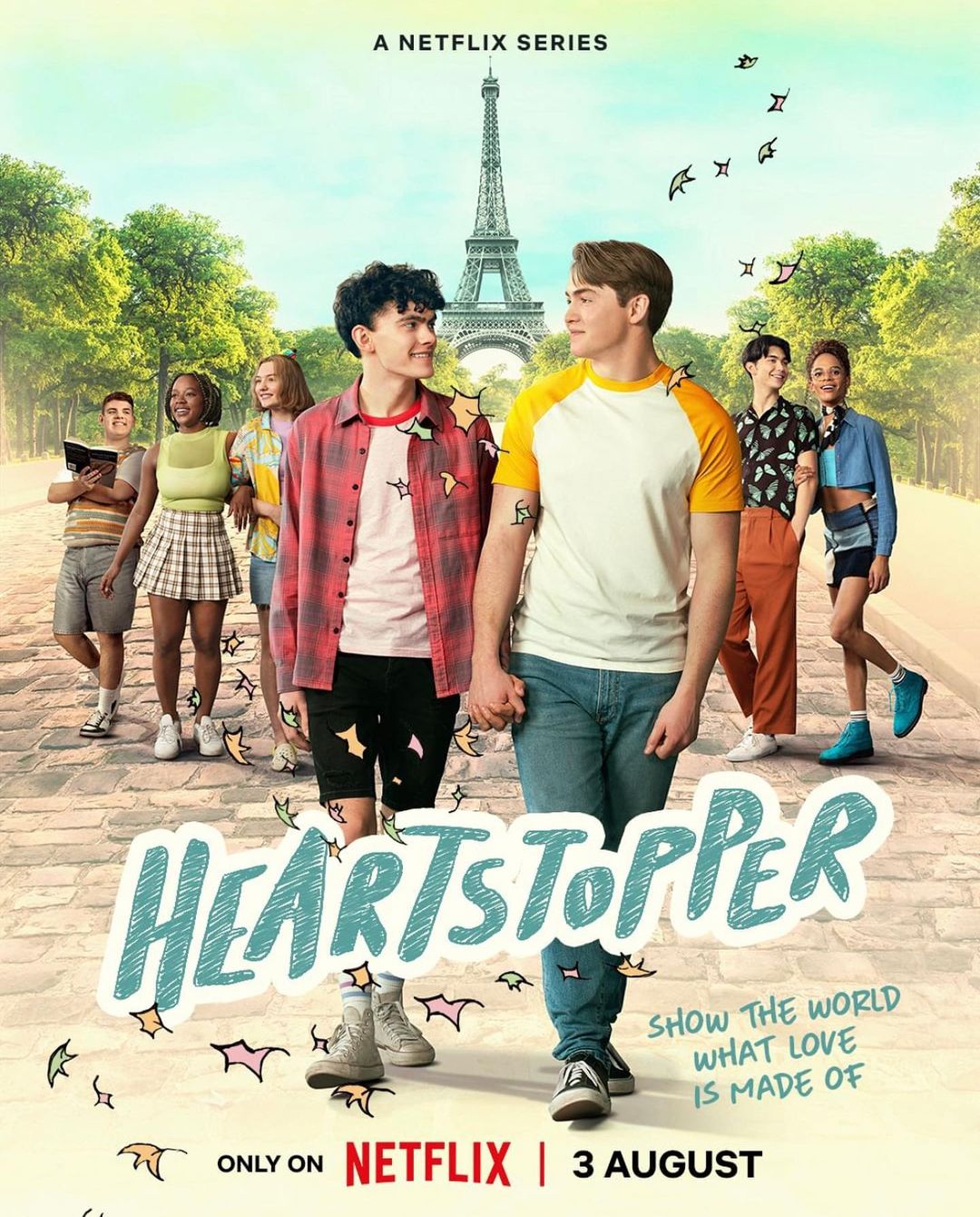 Promotional image for Netflix's Heartstopper, showing a group of teenagers on a sunny street with the Eiffel Tower in the background.