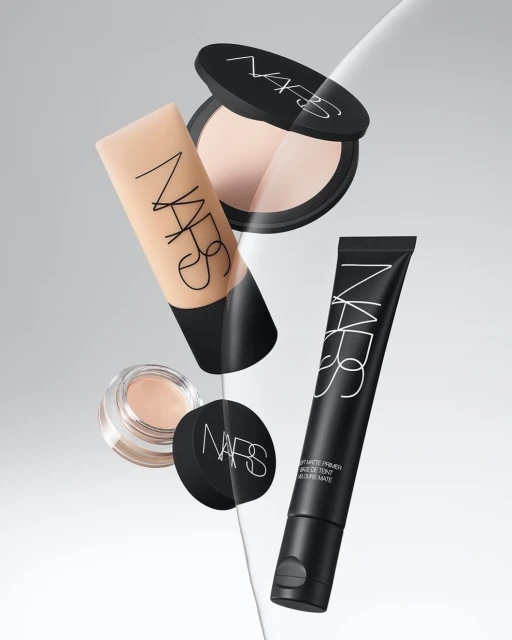 NARS brand makeup product collection featuring foundation, primer, and powder in minimalist studio setting, ideal for beauty campaigns.