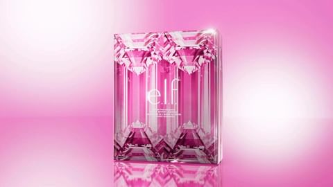 Cosmetic product by e.l.f. in a pink, transparent package with a diamond-like pattern on a pink gradient background with soft, bright lighting.