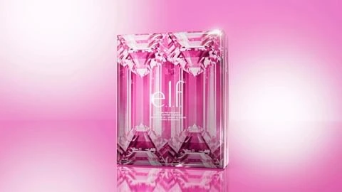 Cosmetic product by e.l.f. in a pink, transparent package with a diamond-like pattern on a pink gradient background with soft, bright lighting.