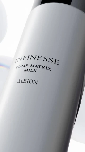 Cosmetic bottle of Infinesse Pump Matrix Milk by Albion. White bottle with black text and cap in a soft, neutral studio setting.