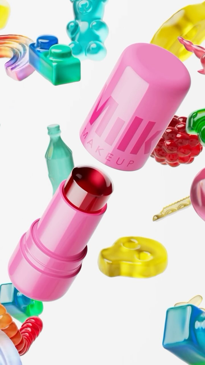 Milk Makeup lip and cheek product floats among brightly colored candy gummies, presented on a clean white background.