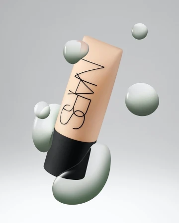 NARS foundation tube with surrounding glossy sphere shapes, showcasing modern beauty product presentation, floating on a soft grey background.