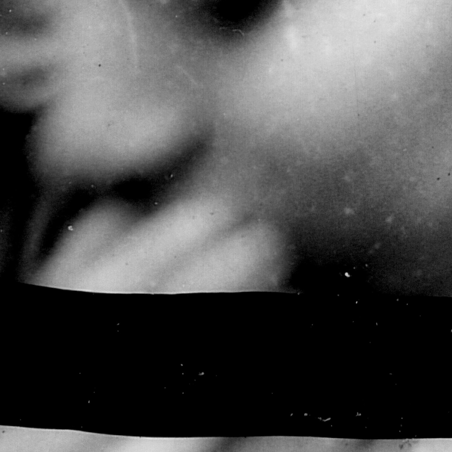 High contrast black and white abstract image with cloudy textures and visible dust-like particles with a dark black stripe across the center.