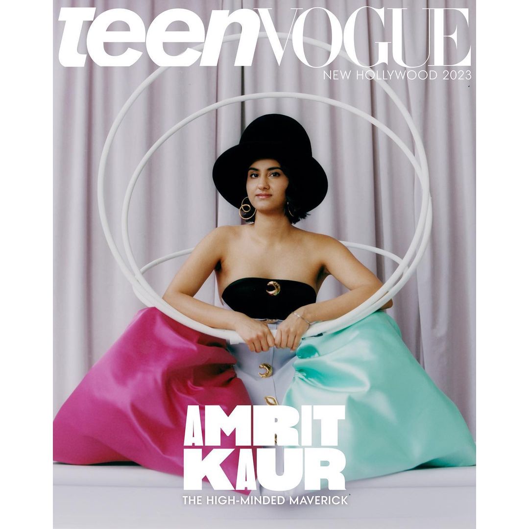 Teen Vogue cover featuring Amrit Kaur in a black top and large hat, seated with pink and teal draped fabric, promoting 'New Hollywood 2023'.