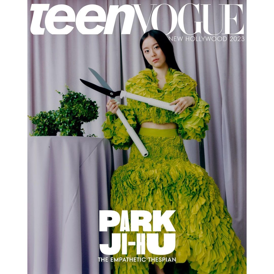 Teen Vogue magazine cover with Asian woman in green floral dress holding giant white-handled shears next to green topiary on table.