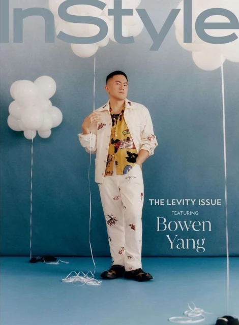 Magazine cover featuring Bowen Yang in patterned white outfit, holding balloon strings, against a blue background, InStyle logo.