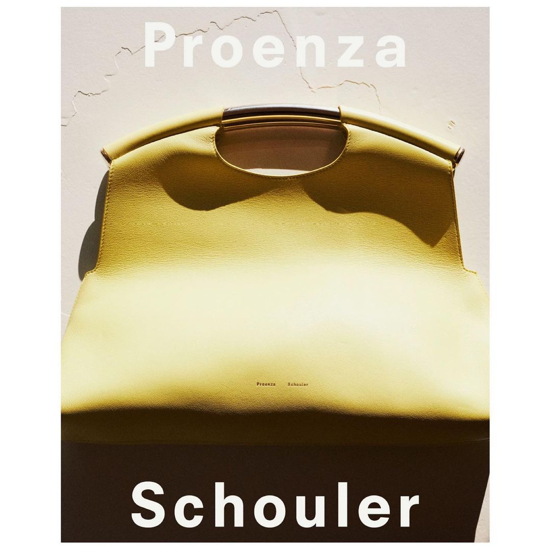 Proenza Schouler leather handbag, light yellow, with a metal handle. Fashion accessory for women, studio lighting, luxury brand product.