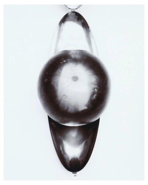 Top-down shot of glass laboratory equipment featuring a round-bottom flask in a pear-shaped mantle on a white background.