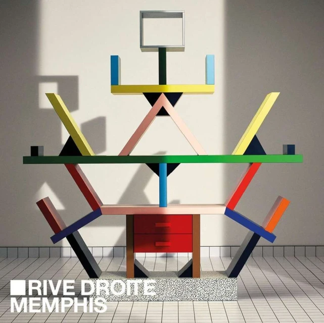 Memphis style furniture with geometric shapes and bright colors against a white background with tiled floor and the words Rive Droite Memphis.