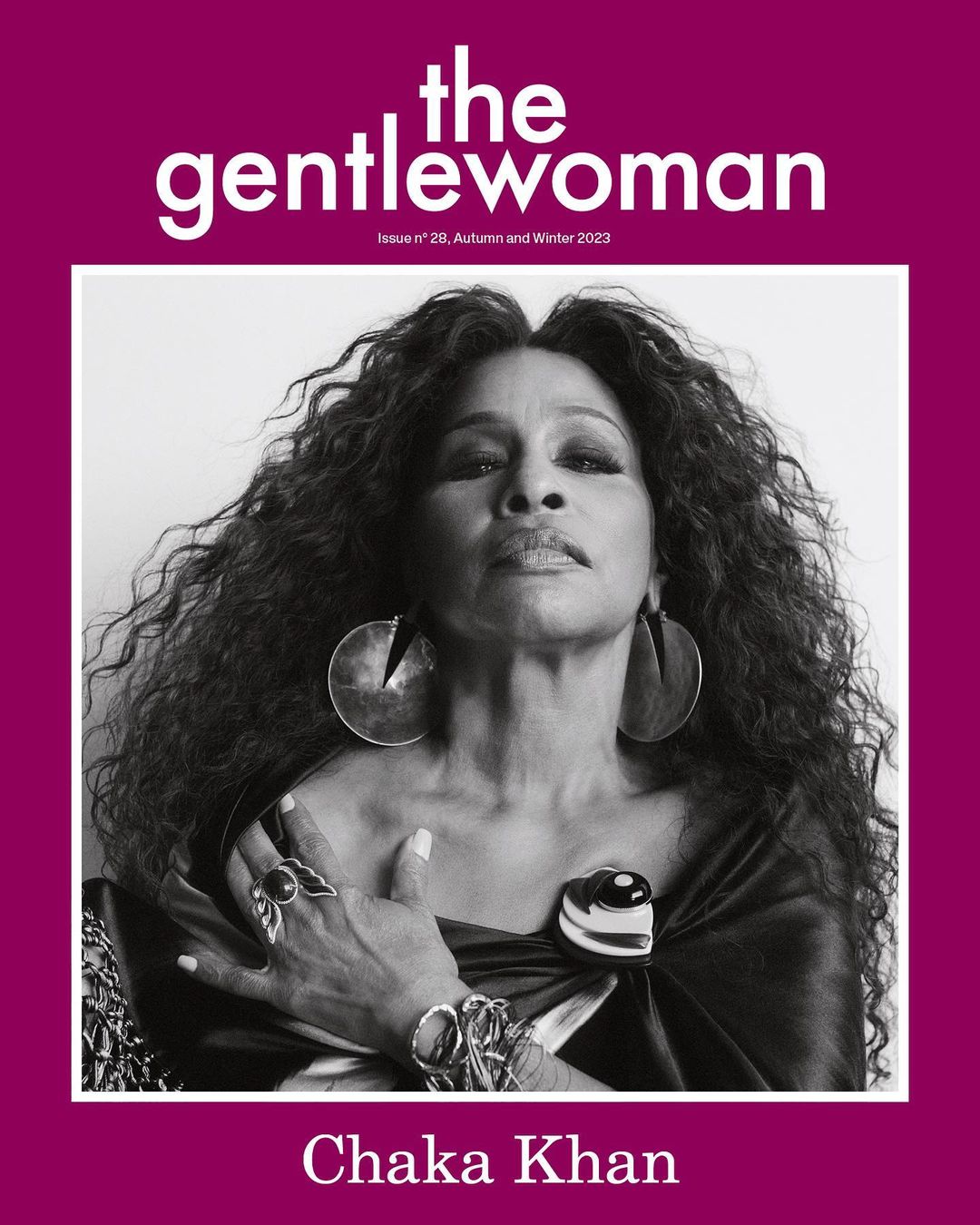 Black and white portrait of Chaka Khan with voluminous curly hair wearing large earrings and rings, photographed by Jody Rogac.