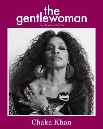 Black and white portrait of Chaka Khan with voluminous curly hair wearing large earrings and rings, photographed by Jody Rogac.