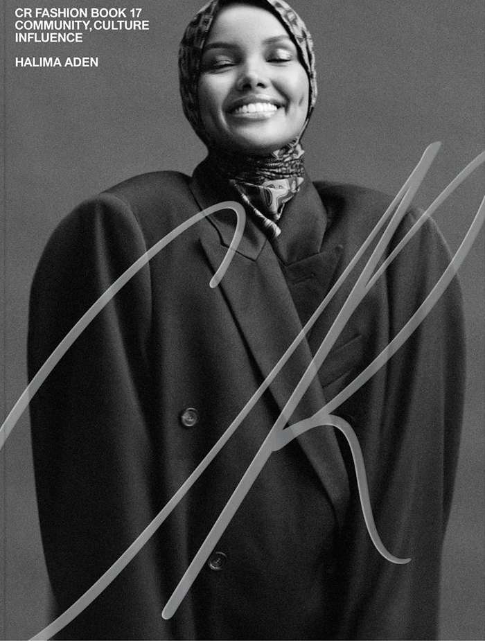 Fashion cover of Halima Aden in a large black blazer and patterned headscarf. CR Fashion Book 17. Community, culture, influence.