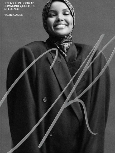 Fashion cover of Halima Aden in a large black blazer and patterned headscarf. CR Fashion Book 17. Community, culture, influence.