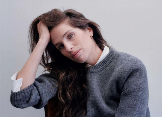 Portrait of a woman with long dark hair wearing a grey knit sweater and white shirt by Jody Rogac
