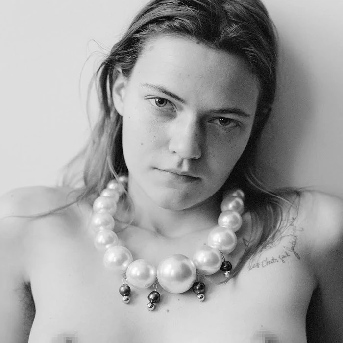 Portrait of a woman wearing a large oversized pearl statement necklace by photographer Jody Rogac.