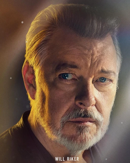 Close-up portrait of a mature adult male with graying hair and beard, looking directly at the viewer with a serious expression.