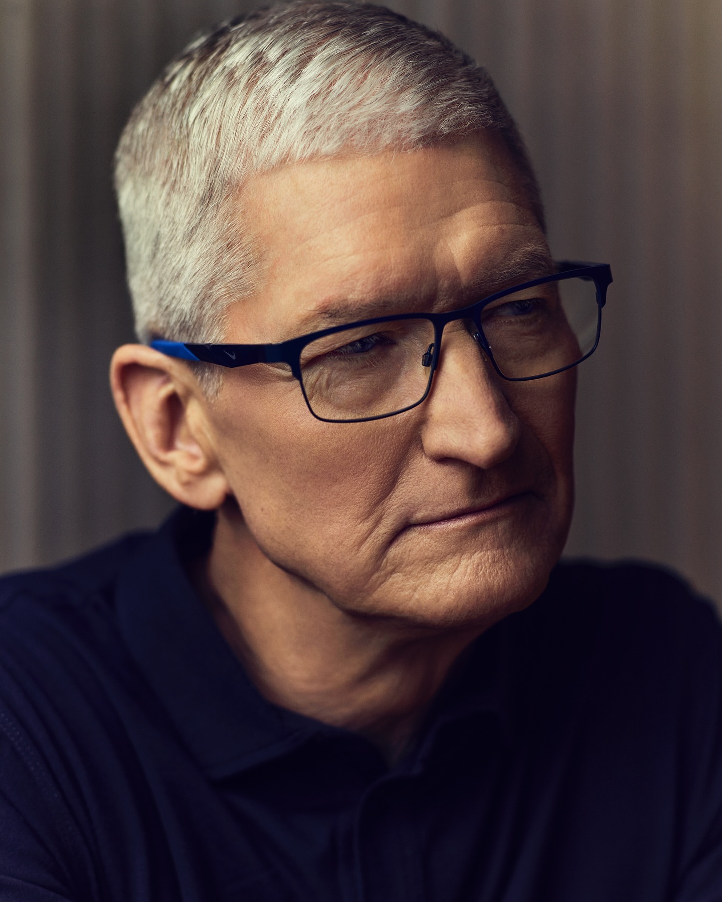 Close-up portrait of Tim Cook wearing dark glasses in a portrait by Joe Pugliese